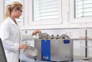 Woman Cleaning Sieves