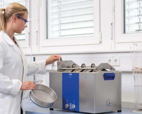 Woman Cleaning Sieves